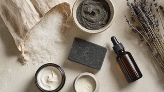 Assortment of Dead Sea bath salt, mineral mud, mud soap and creams on limestone